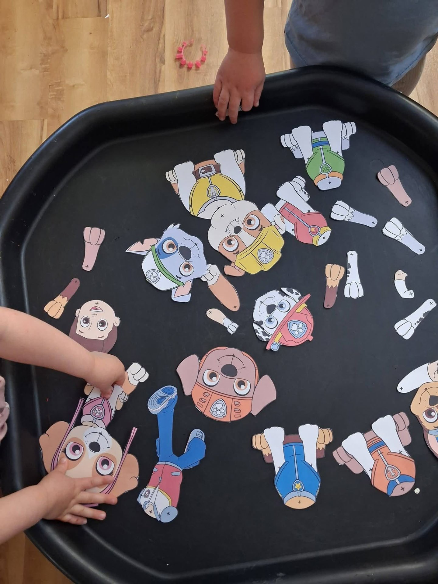 Children building character puzzles in the tuff tray